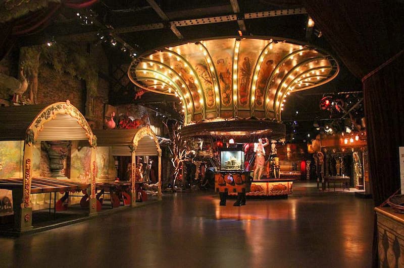 Interior of a circus museum in Paris showing props and circus tents.
