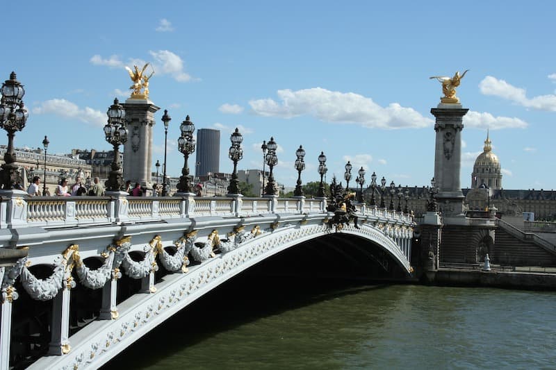 Side view of the statue-lined Pont Alexandre bridge in Paris.