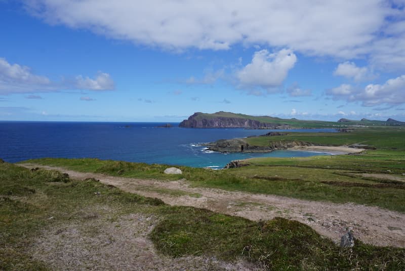 Green field, brown cliffs and blue water on the Dingle Peninsula in Ireland