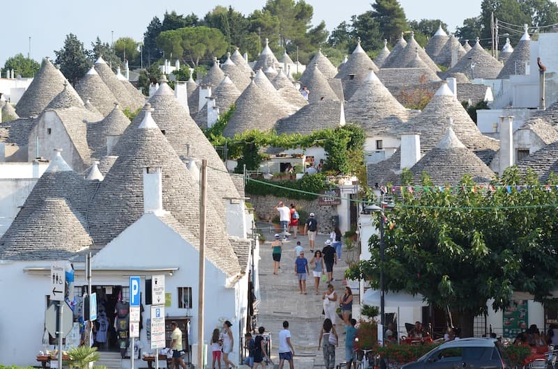 People walking the streets of Alberobello, Italy