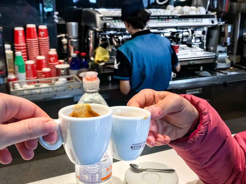 Two espresso cups clanking in a "cheers"