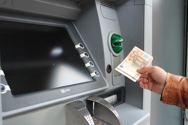 Person withdrawing euros from an ATM