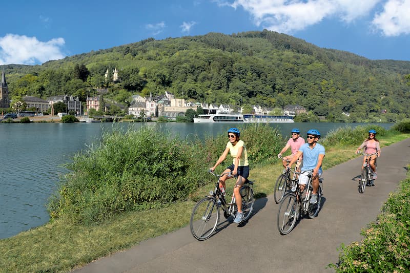 Four people biking along the Moselle River