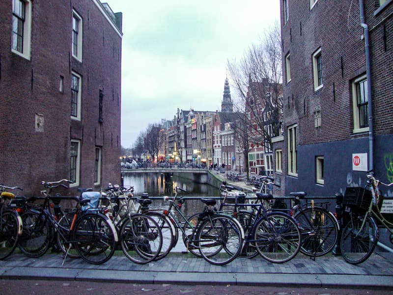 Bikes stacked up along a canal bridge in Amsterdam