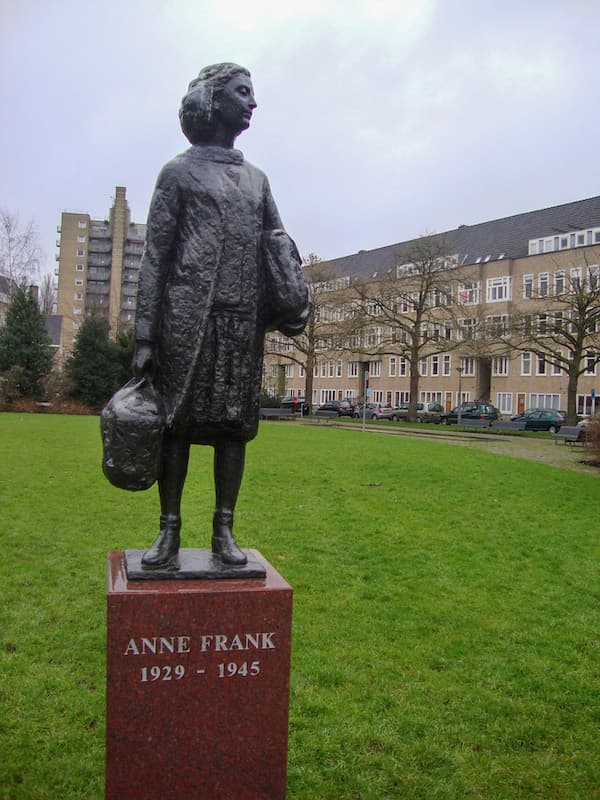 A statue of Anne Frank nearby her family's old apartment in Amsterdam