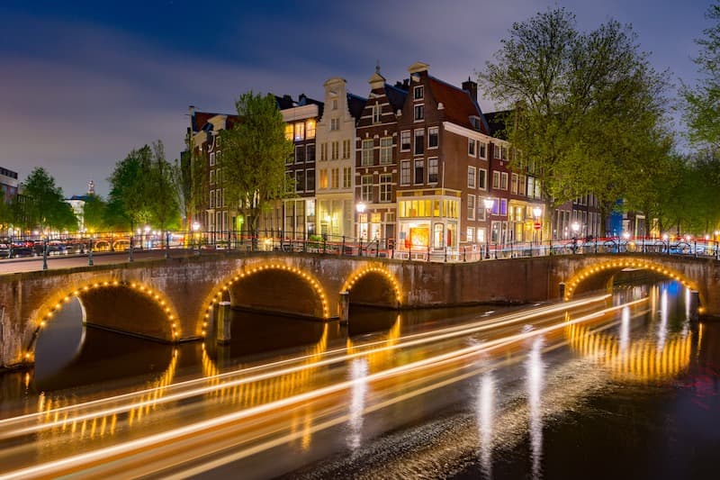 Amsterdam canal bridges with golden lights