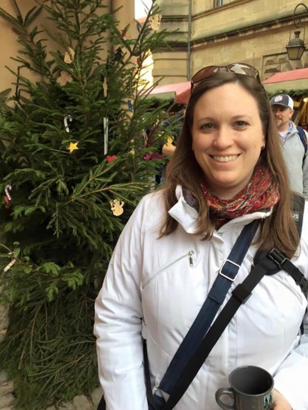 Cassie Tetro standing in front of a Christmas tree at a German Christmas Market
