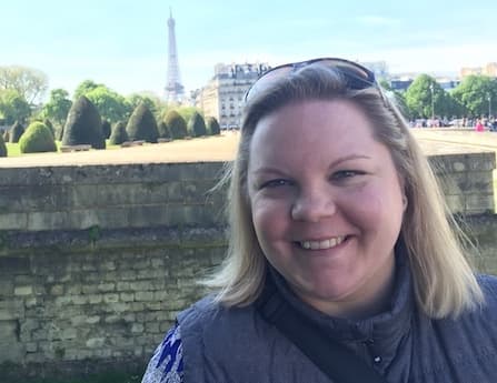 Clarice smiling in front of Eiffel Tower in Paris