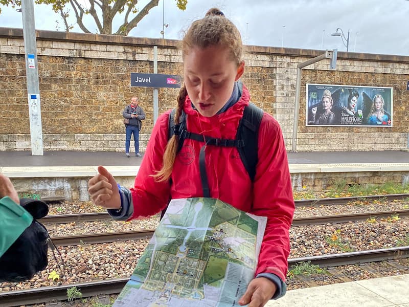 Tour guide showing tourists a map of the grounds of Versailles