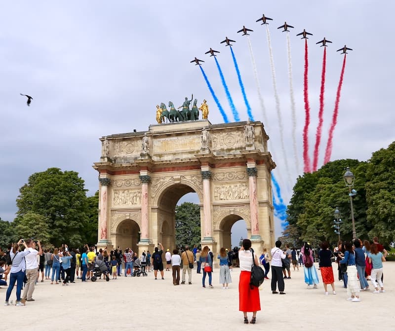 Figher jets fly over the Arc du Caroussel during Bastille Day in Paris