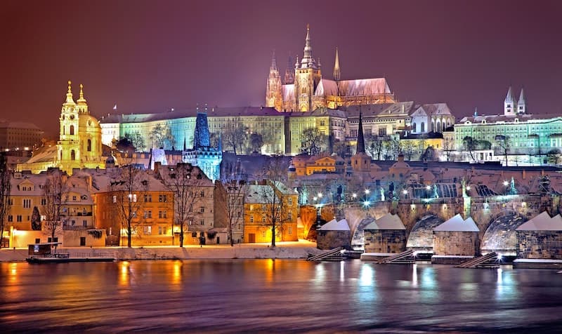 The Charles Bridge and Prague Castle covered in snow in winter