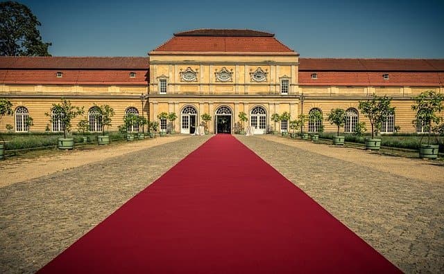 Red carpet leading to the entrance of a castle
