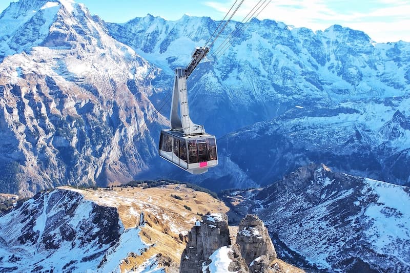 Ski gondola soaring over the Swiss Alps